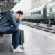 Man despairing at train station
