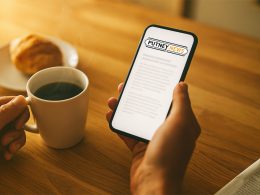 Putney.news being read on a phone with a coffee