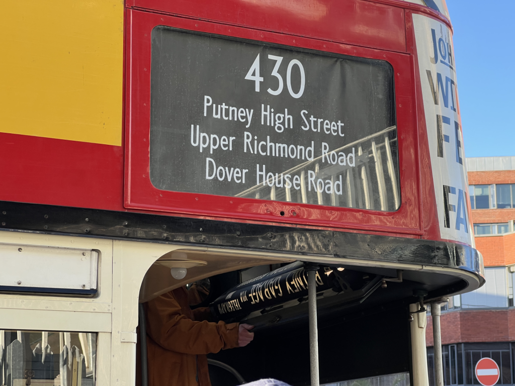 A volunteer cranks the destination blind by hand on the 1930s STL bus