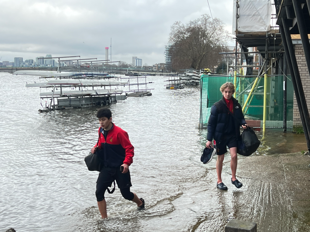 Rowers wading through flood waters at Putney Embankment