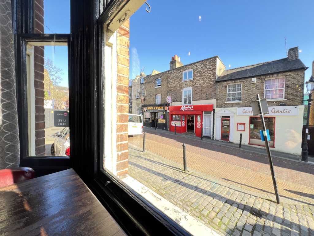 Looking out the window onto Roehampton High Street from the Angel pub