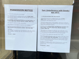 Two posted legal notices taped to a window: a 'Possession Notice' and a 'Tort (Interference with Goods) Act 1977' notice.