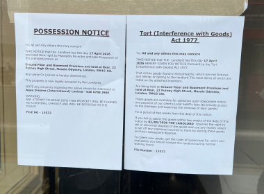 Two posted legal notices taped to a window: a 'Possession Notice' and a 'Tort (Interference with Goods) Act 1977' notice.