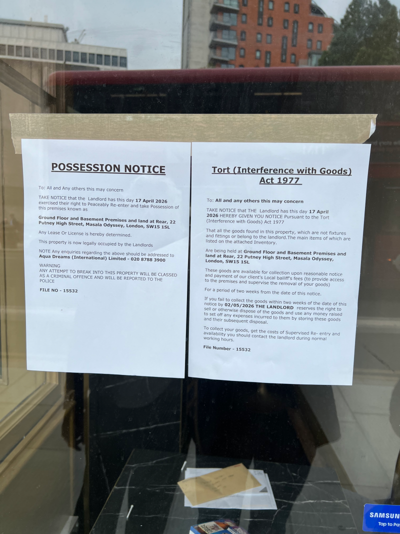 Two posted legal notices taped to a window: a 'Possession Notice' and a 'Tort (Interference with Goods) Act 1977' notice.