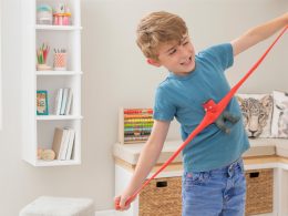 A child stretching a red Stretcherz Stretch Squad toy, which has been recalled after asbestos was found in its filling
