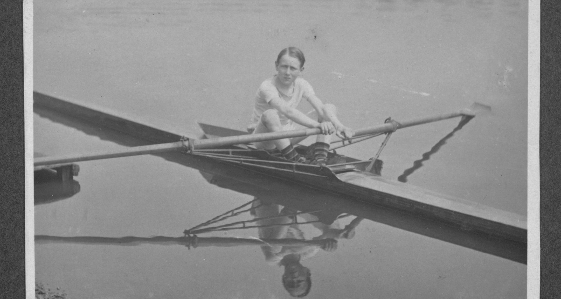 Black and white photograph of a 12-year-old Jack Beresford on the Thames in 1911, with his name written in his own handwriting beneath the image.