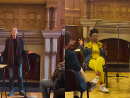 Panel discussion in a wood-paneled room; woman in a bright yellow suit gestures while another speaker stands at a microphone.