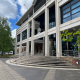 Front of Crown Court building with tall concrete columns, steps, and crest above the entrance.