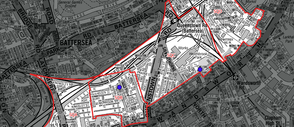 Grayscale street map showing red-outlined blocks around Battersea/Clapham and two blue markers along the rail lines.