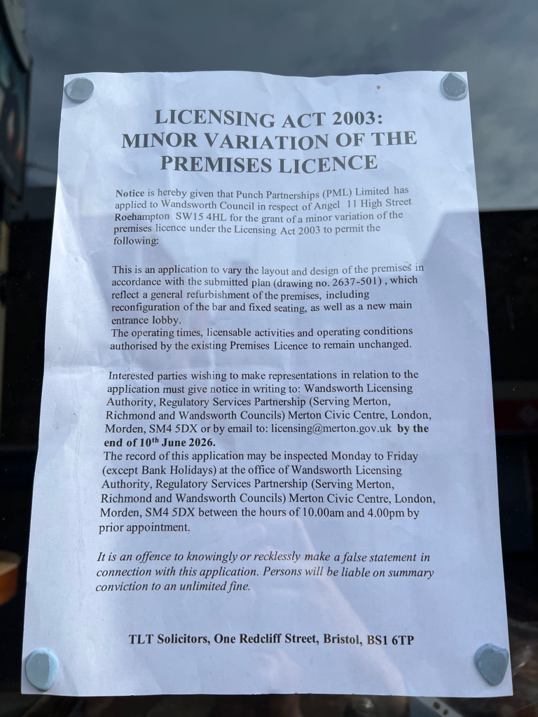 Notice titled Licensing Act 2003: Minor variation of the premises licence pinned to a glass surface