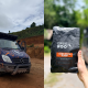 Two-panel photo: left shows a blue off-road van with people on the roof rack driving on a dirt track; right shows a hand holding a Curious Roo Barn Door Blend coffee bag outdoors.