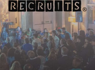 Poster of a live band event with 'Rock & Roll Recruits' title and a crowd watching a performance on stage, date shown at bottom.