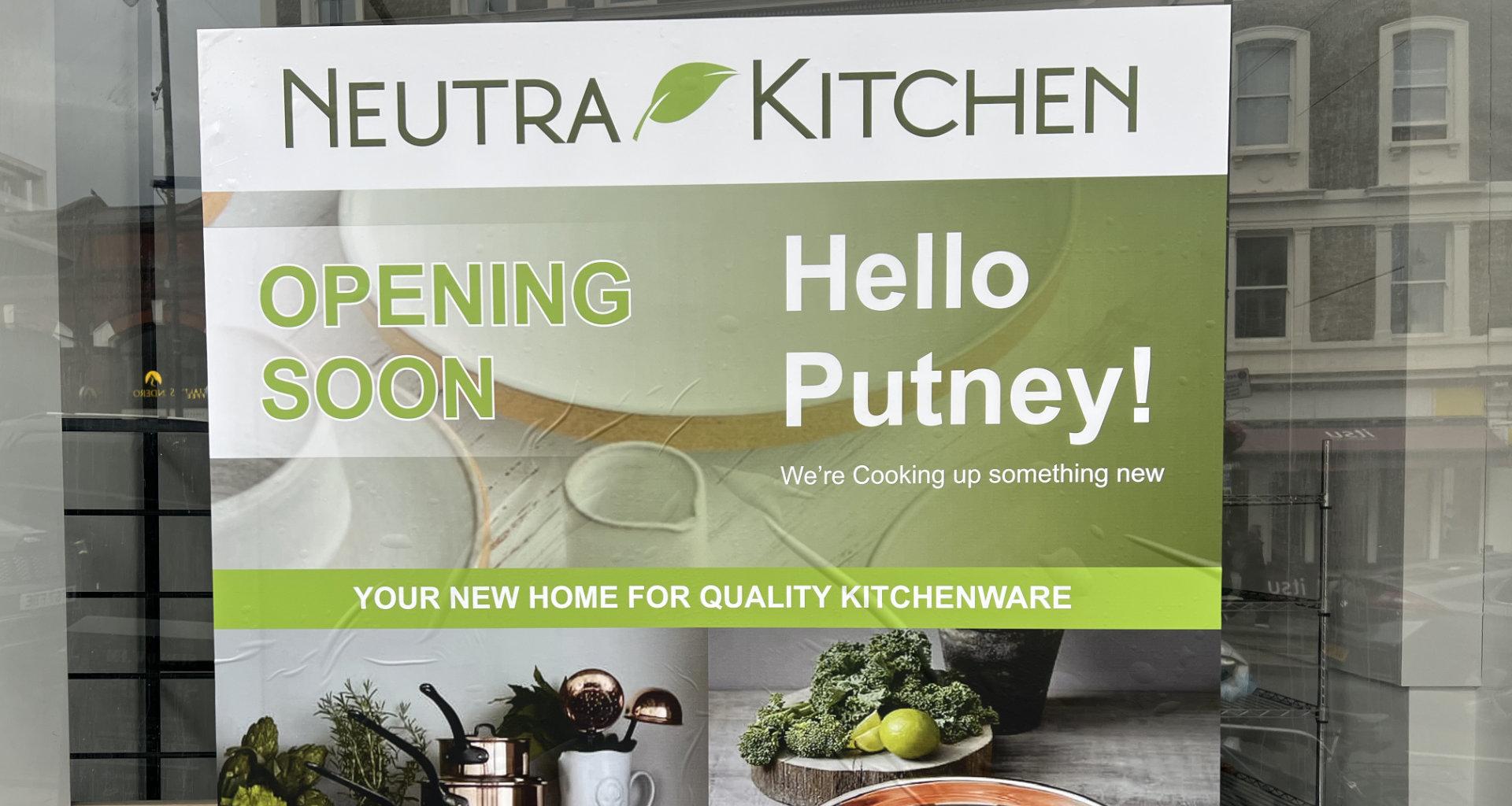 Sign for Neutra Kitchen announcing opening soon in Putney, with a green banner and 'Hello Putney!'