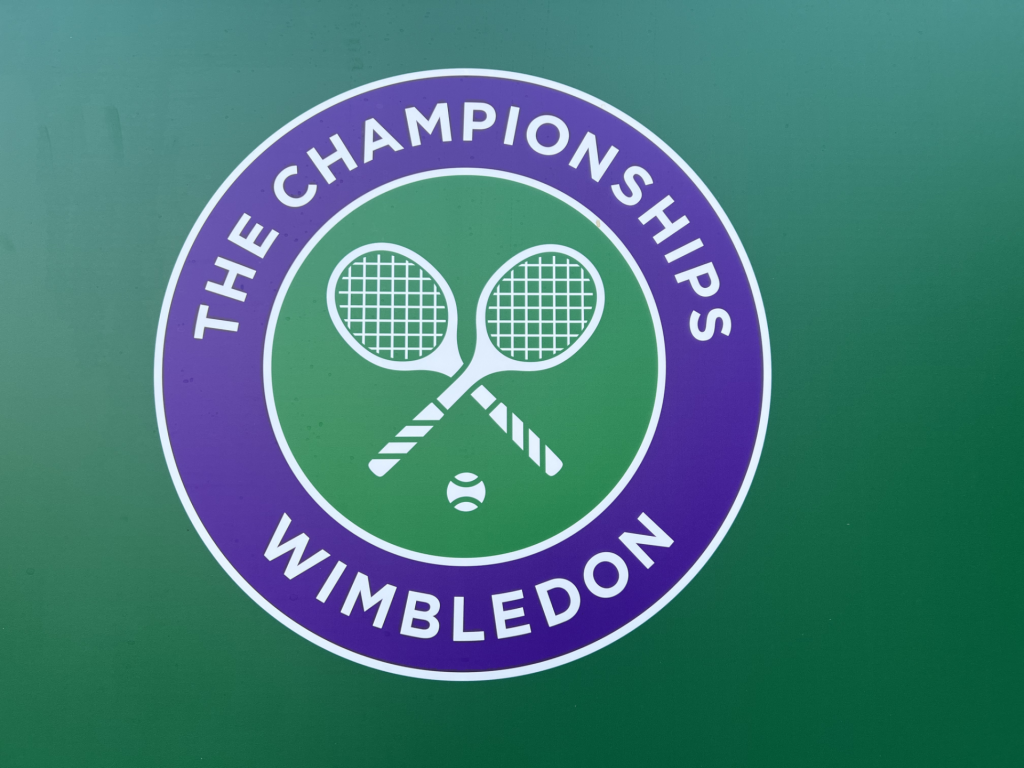 Wimbledon Championships logo on a green background with crossed tennis rackets inside a purple circle.