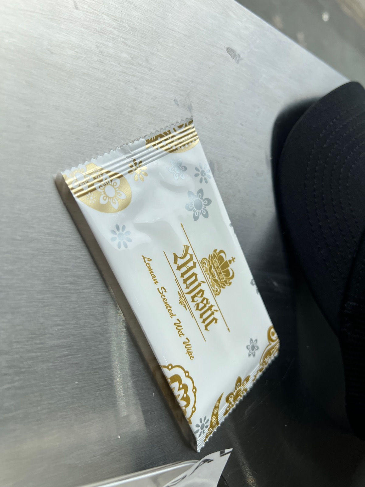 Lemon-scented wet wipe on a steel table