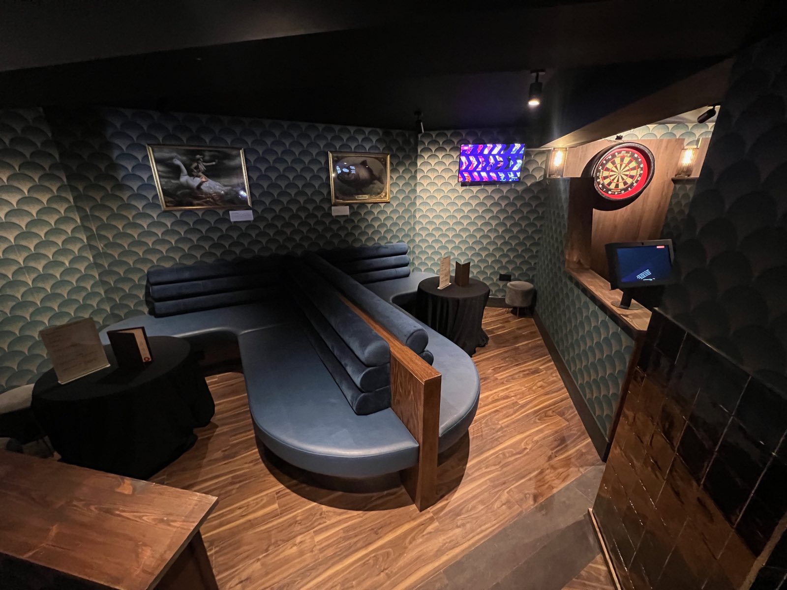 Banquette seating beside a darts lane