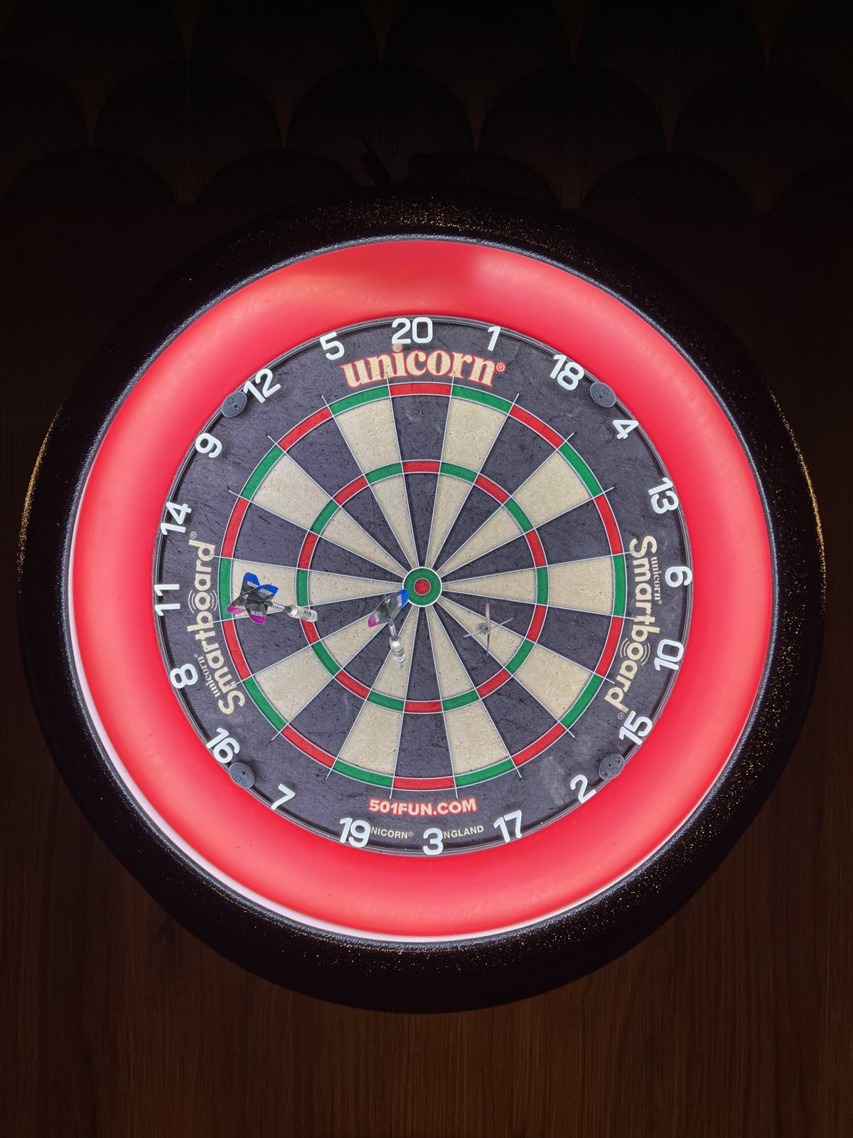 A lit electronic dartboard at Annie's Room