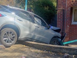 The car wedged against the brick front of the block on Clarence Lane, two days after the crash. Pic: Antony Arthur