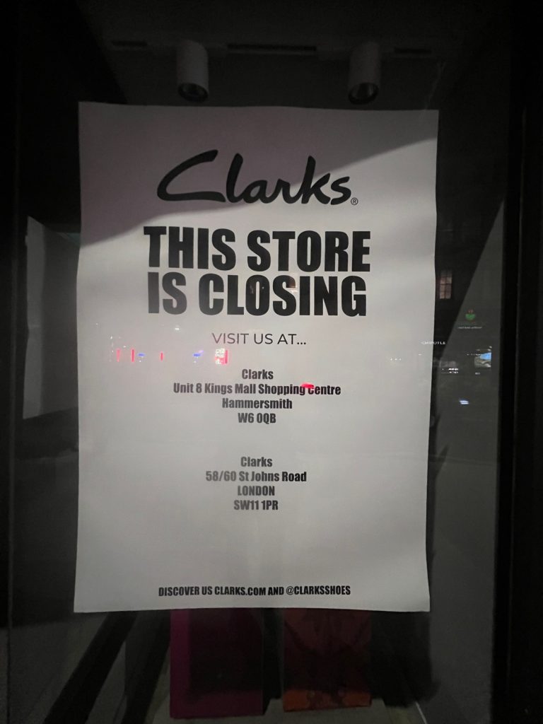 Clarks poster reading "This store is closing, visit us at" with addresses in Hammersmith and on St Johns Road, SW11