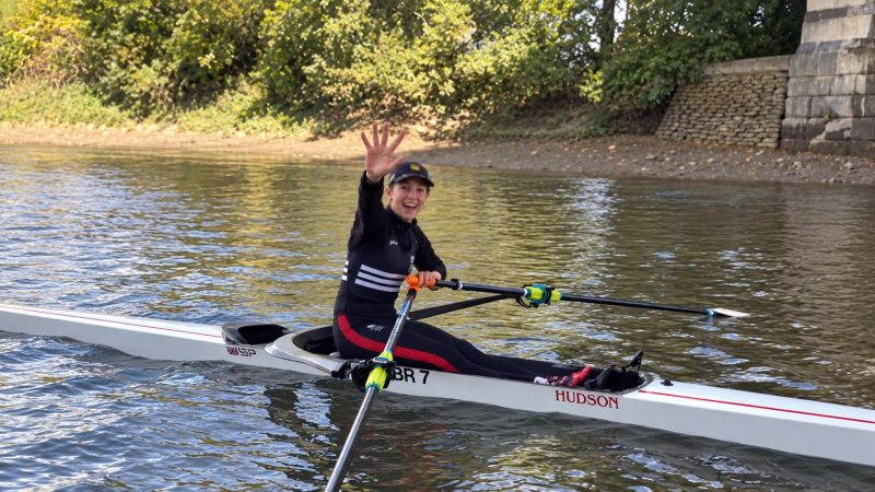 Imogen Grant raises five fingers from her rowing boat to celebrate winning the Wingfield Sculls for the fifth time.