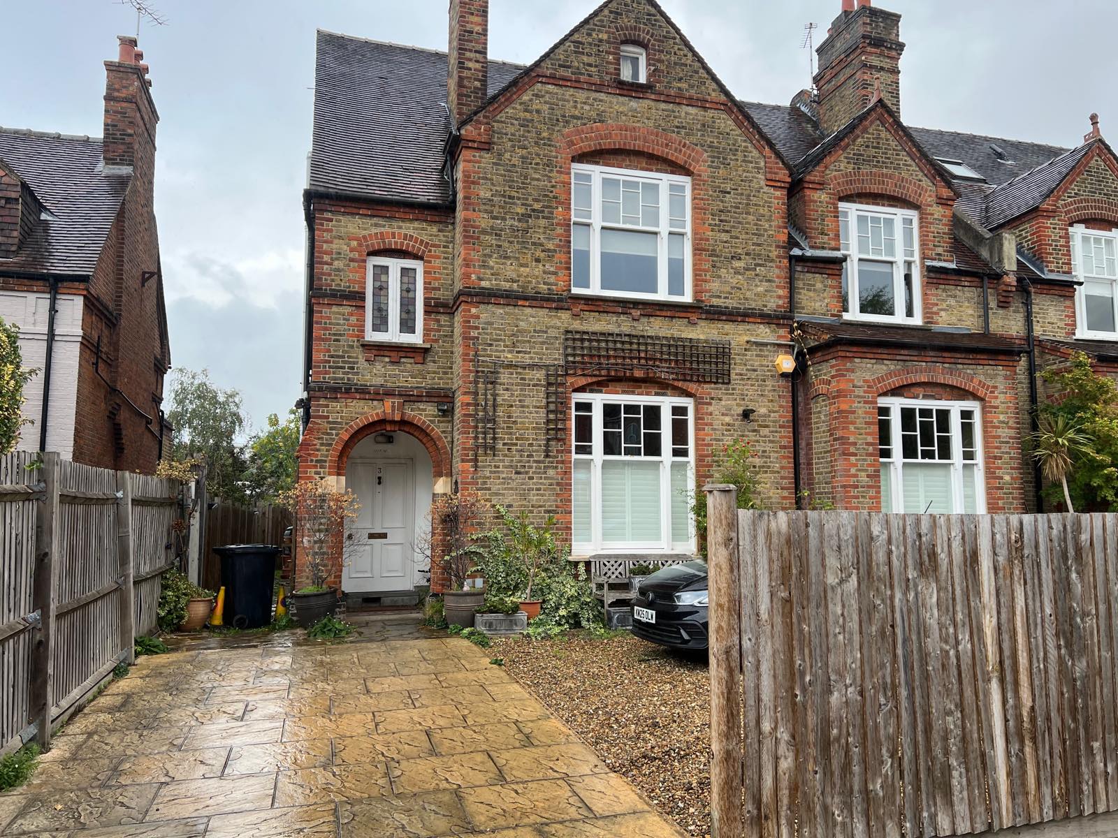 Victorian yellow-brick house with a red-brick arched porch, number 3 on the door