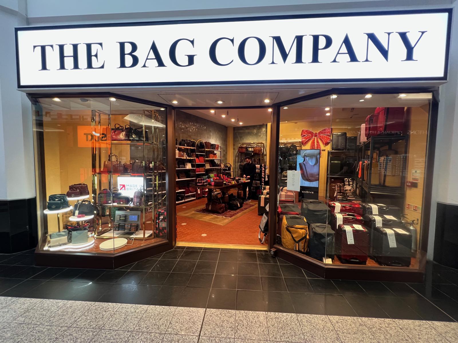 The Bag Company shopfront in Putney Exchange with handbags and suitcases in the windows