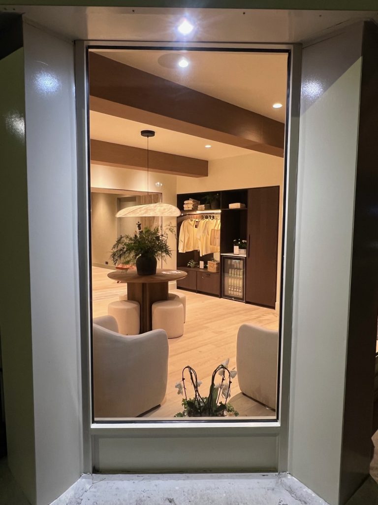 The lit front area of Sculpt House seen through its window after dark