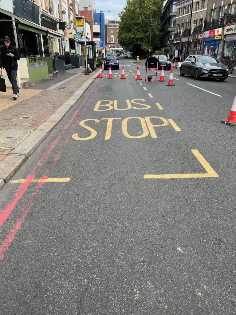 A bus stop marking on Upper Richmond Road coned off beside the Thames Water works