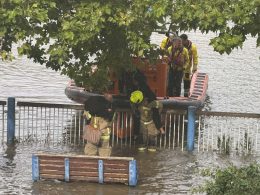 Women lifted onto a lifeboar afte the tide came in at Putney Embankment