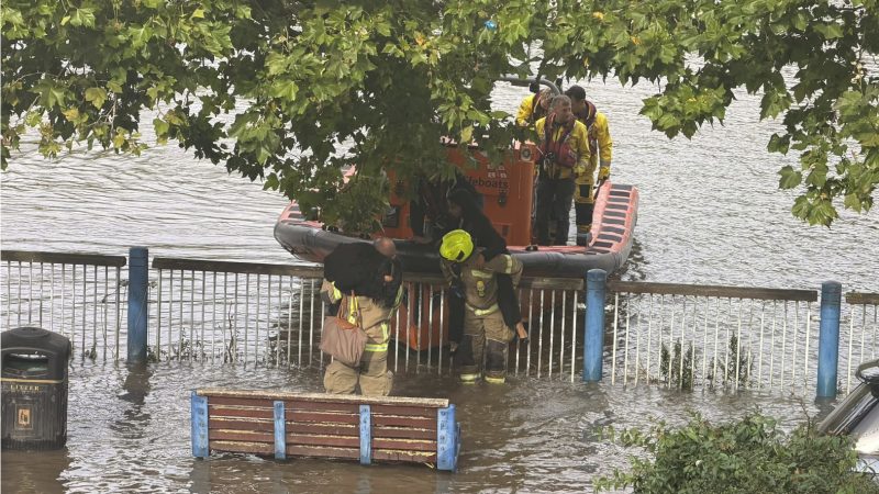 Women lifted onto a lifeboar afte the tide came in at Putney Embankment